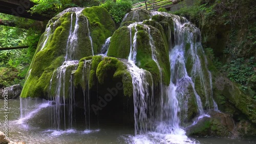 Beautiful unique Bigar Waterfall in Romania on the Edge of the Road passing through the carpatian Mountains