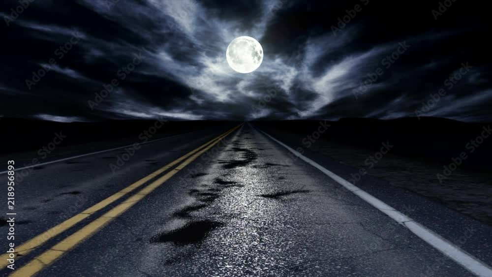 Driving down a night road under cloudy sky with moon, loop