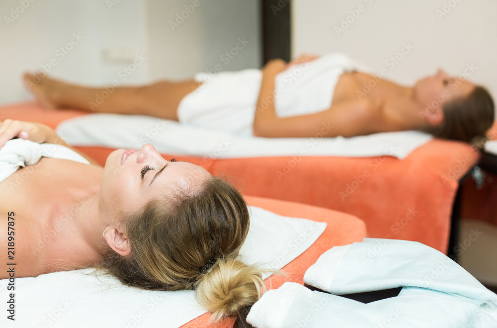 Two cute young women enjoying during a skin care treatment at a spa. massage and beauty treatments in the beauty salon Two cute young women enjoying during a skin care treatment at a spa. massage and beauty treatments in the beauty salon