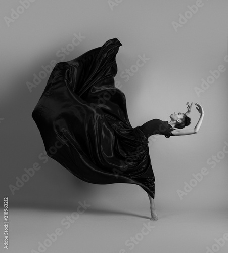 Ballerina in a flying black dress
