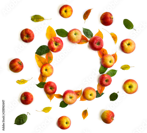 Frame of ripe yellow-red juicy apples and fall apple tree leaves on a white background with space for text. Top view, flat lay