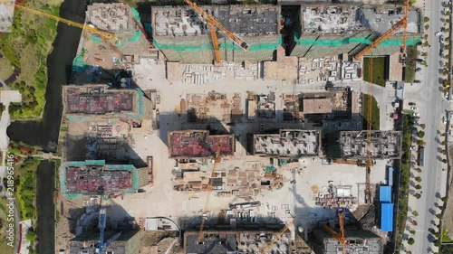 Time lapse of top down view of construction site. Timelapse of China residential construction view from above. Busy bustling building site bird's eye view. photo