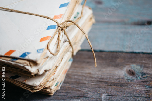 Stack of vintage letters on wooden table