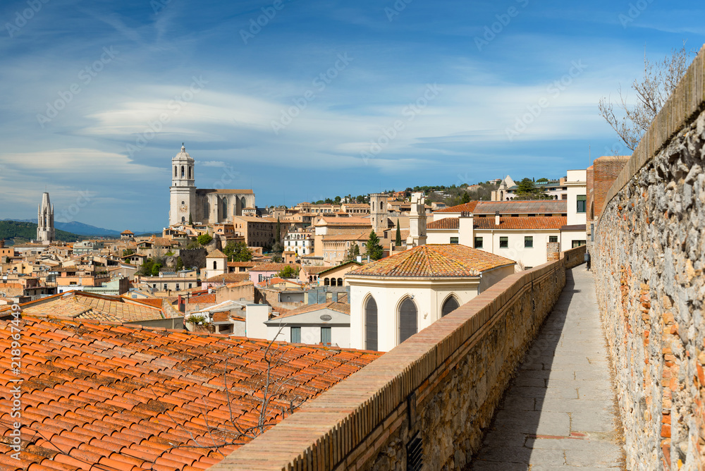 Girona skyline from the medieval city walls, Catalonia, Spain. Towers of cathedral and basilica. Aerial view