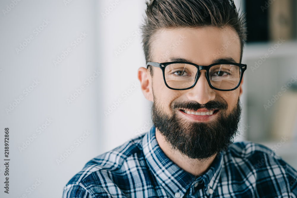 close-up portrait of bearded smiling man in eyeglasses looking at camera close-up portrait of bearded smiling man in eyeglasses looking at camera