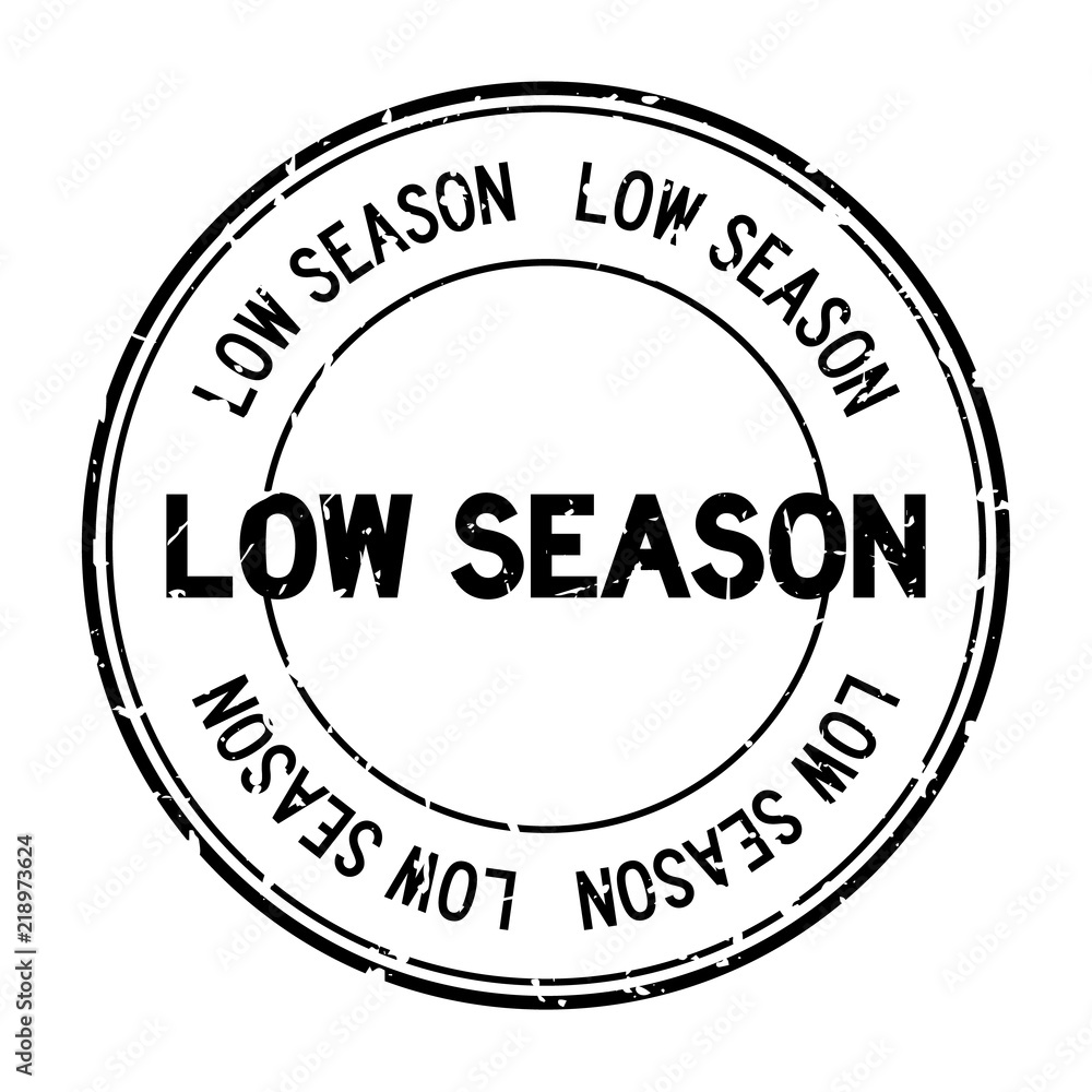 Grunge black low season word round rubber seal stamp on white background