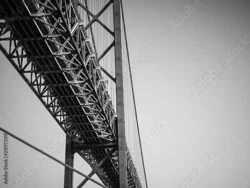 25 de Abril Bridge, Lisboa, Portugal. Black and white abstract detail from under the 2km landmark suspension bridge over the Tagus River, Lisbon.