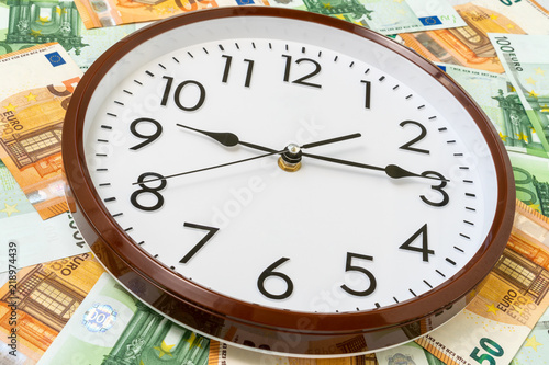 Clock and Euro currency banknotes