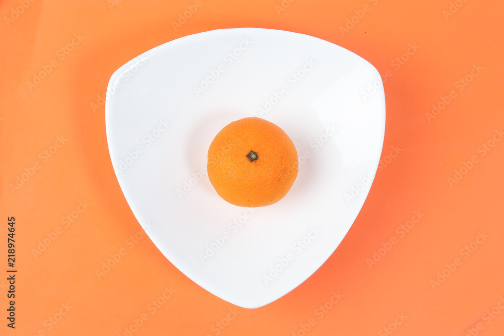 Mandarin Orange Fruit slice half juiced extracted on hart shape plate orange background Mandarin Orange Fruit slice half juiced extracted on hart shape plate orange background
