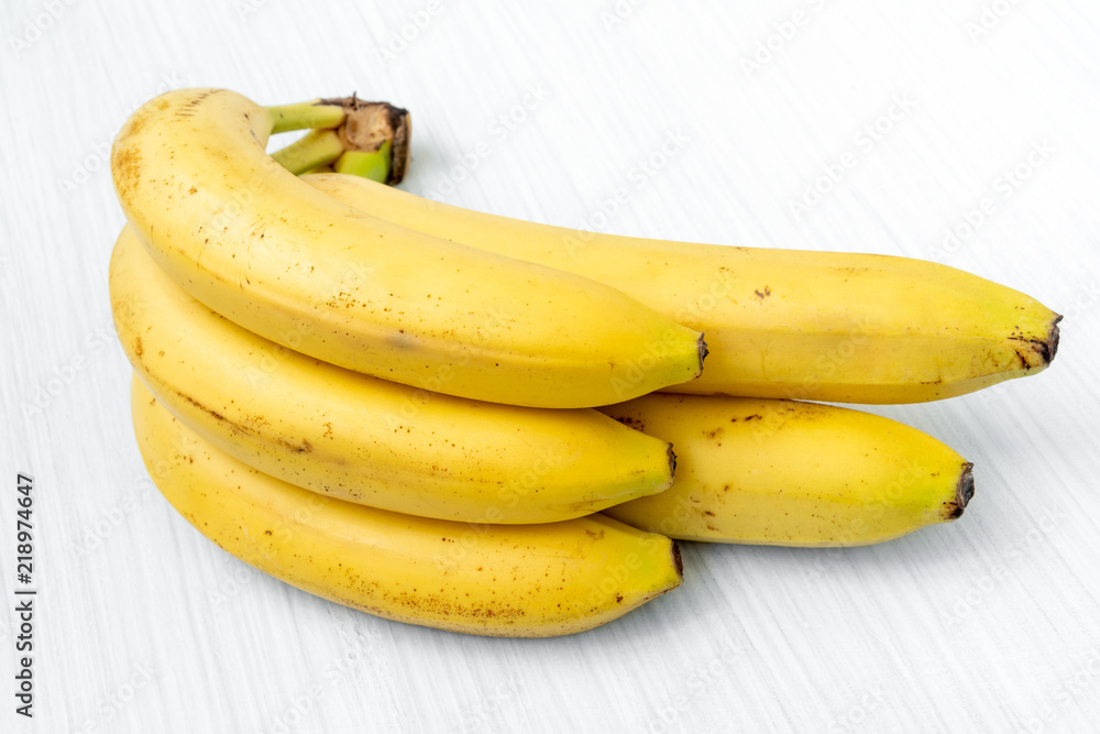 Sweet bananas on white wooden table