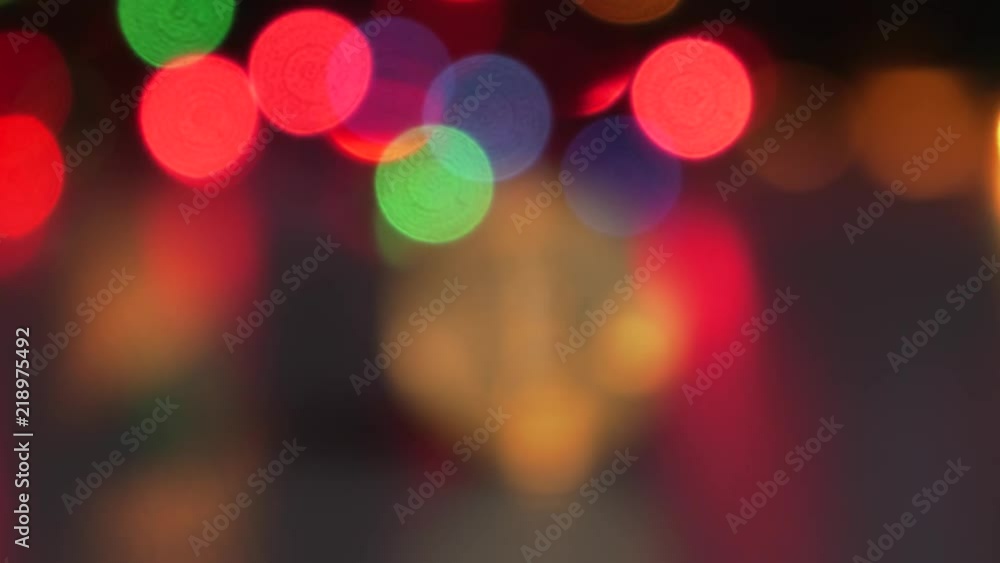 Golden Bitcoin currency. Festive atmosphere. Colorful Christmas tree lights in the background. BTC is a cryptocurrency and is the first decentralized peer-to-peer payment network.4K, Panning, Closeup. Golden Bitcoin currency. Festive atmosphere. Colorful Christmas tree lights in the background. BTC is a cryptocurrency and is the first decentralized peer-to-peer payment network.4K, Panning, Closeup.