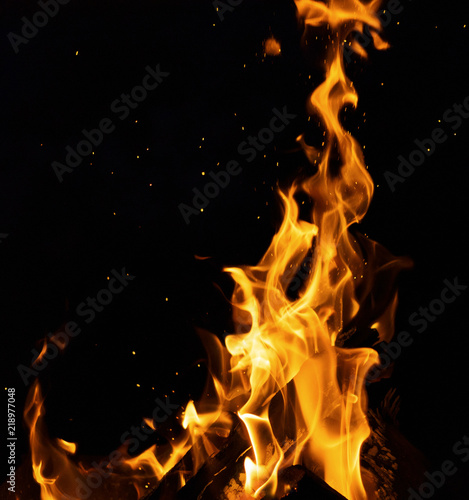 burning wooden logs with high flames and sparks