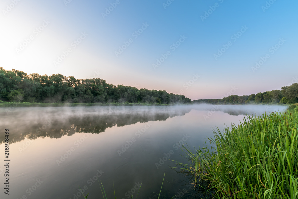 sunrise on the river. fog on the river. panoramic view, trees reflected in the water