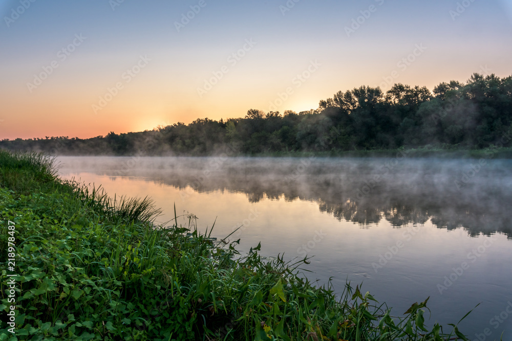 sunrise on the river, the red sky before sunrise. fog on the river