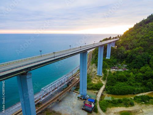 Drone view of the Zubova Schel viaduct and mountainside with forest on the background of the sea in overcast summer day, Sochi, Russia
 photo