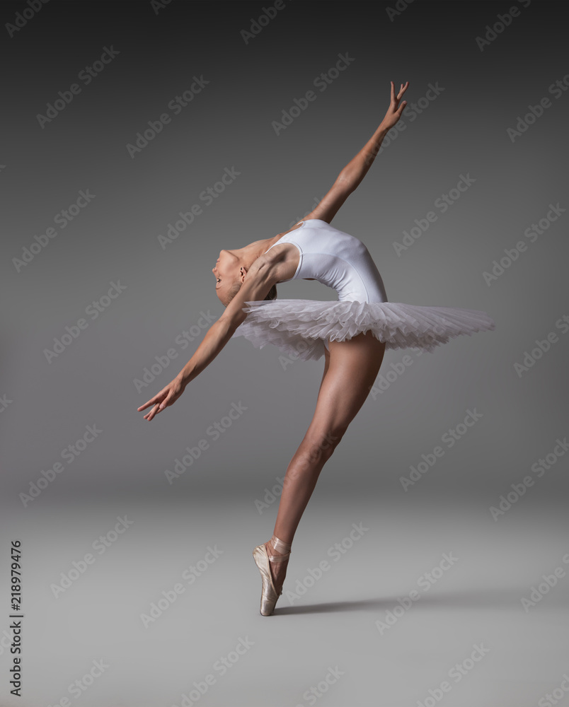 Ballerina in a tutu and pointe shoes makes a beautiful pose Stock