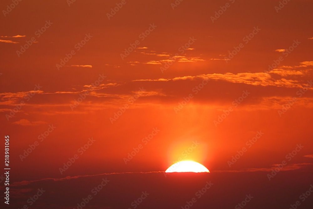 Beautiful orange fiery sunset background over the city, the sun sets below the horizon Beautiful orange fiery sunset background over the city, the sun sets below the horizon
