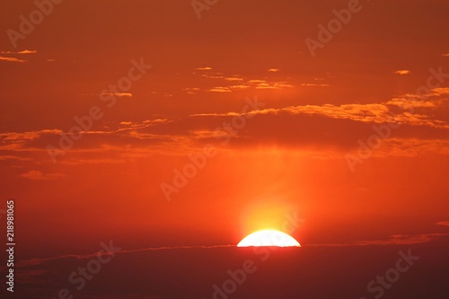 Beautiful orange fiery sunset background over the city, the sun sets below the horizon