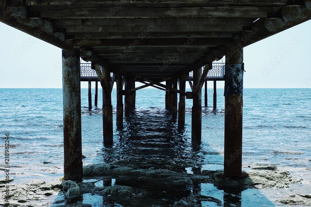 Aktau / Kazakhstan - APR 28 2011: old pier leading to the caspian sea from the desert Aktau / Kazakhstan - APR 28 2011: old pier leading to the caspian sea from the desert