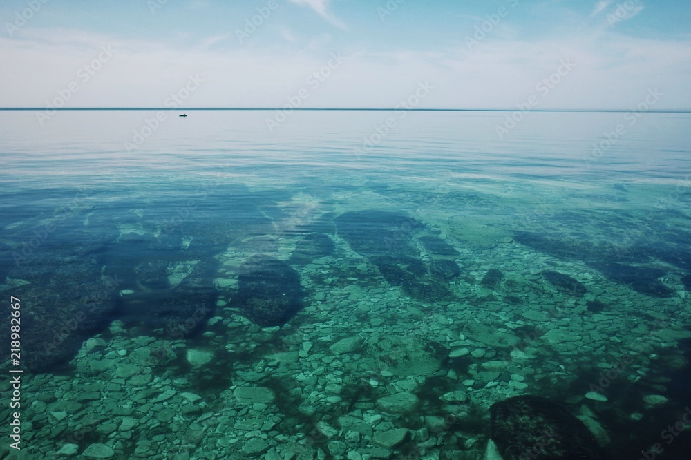 Obraz premium Aktau / Kazakhstan - APR 28 2011: calm flat sea shore of the caspian sea at midday