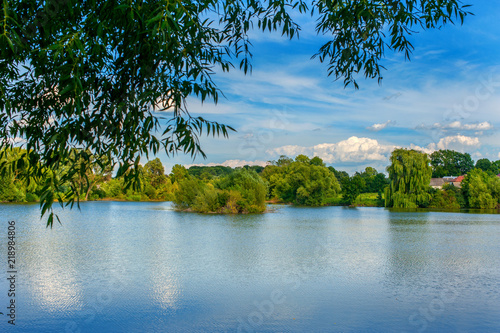 Tranquil landscape at a lake, with the vibrant sky and clean blue water