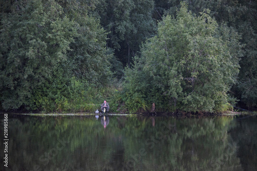 Russia,Moscow,- august 18 2018/fisherman on the forest lake - an evening biting