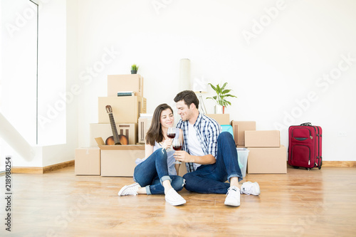 Couple Celebrating Moving To New Home With Red Wine © AntonioDiaz