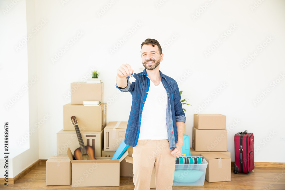 Successful Man Showing House Keys While Standing At New Home Successful Man Showing House Keys While Standing At New Home