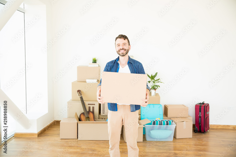 Householder With Corrugated Box Standing In New Home