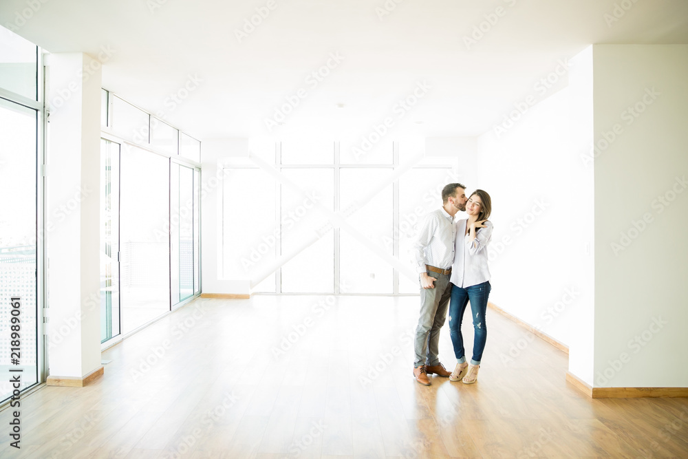 Man Kissing Woman On Cheek In New Apartment Man Kissing Woman On Cheek In New Apartment