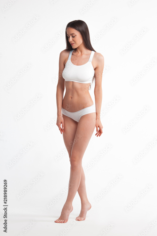 Slim young woman in underwear on white background Slim young woman in underwear on white background