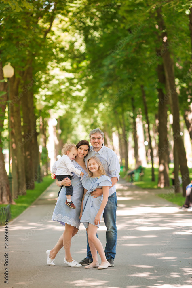 Happy family with two kids in the park Happy family with two kids in the park