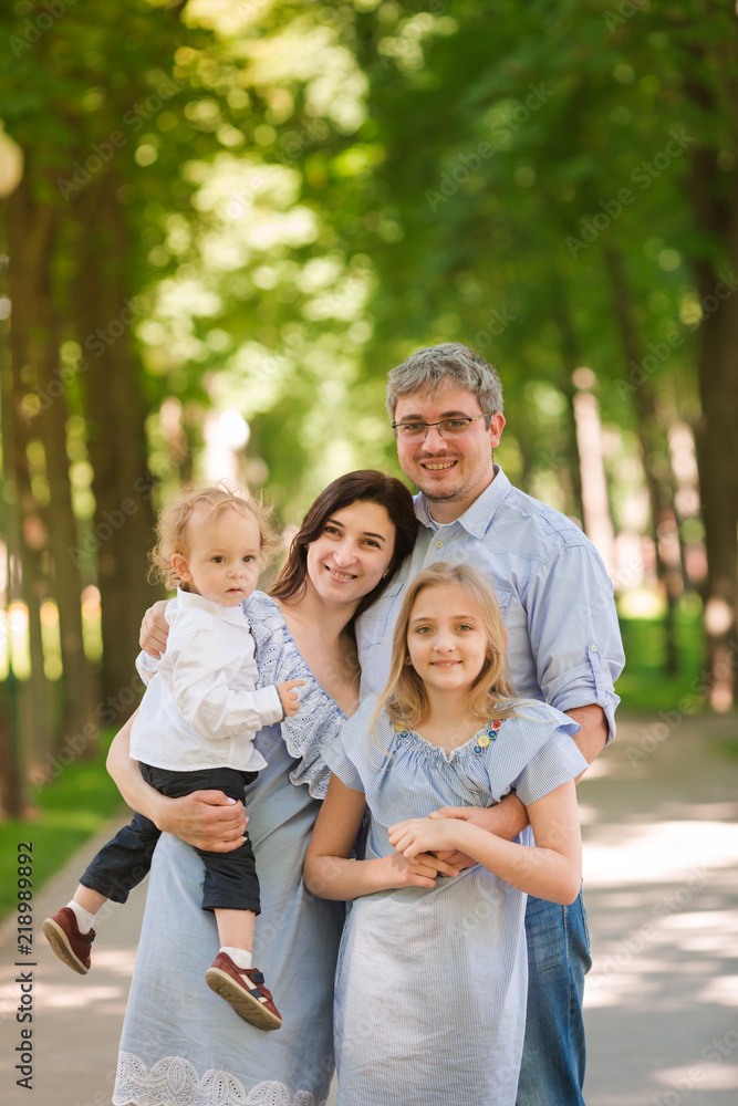 Happy family with two kids in the park Happy family with two kids in the park