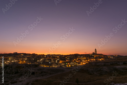 View of Matera during sunset  from the park of Murgia Materana. Romantic sunset over the italian city of Matera.