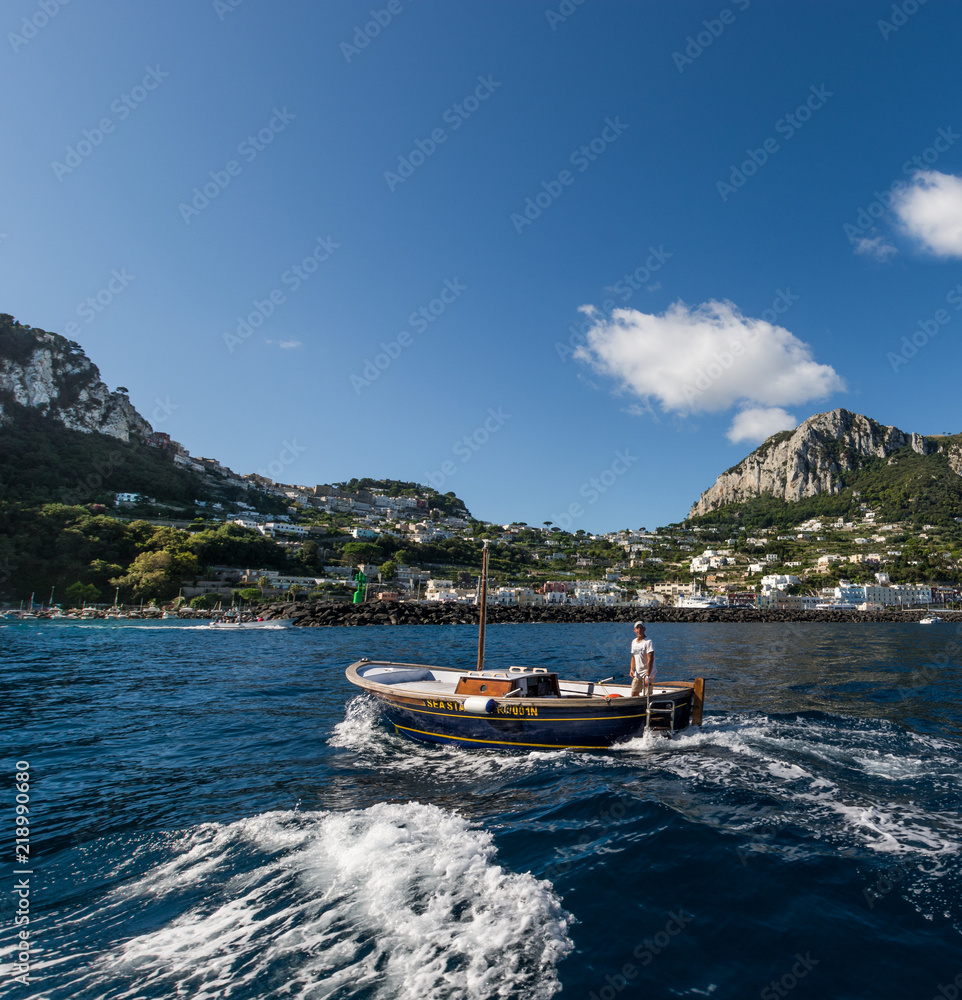 CAPRI, CAMPANIA, ITALY - 22 AUGUST 2018: Iconic view od the island of Capri, from the sea, during a sunny day. 