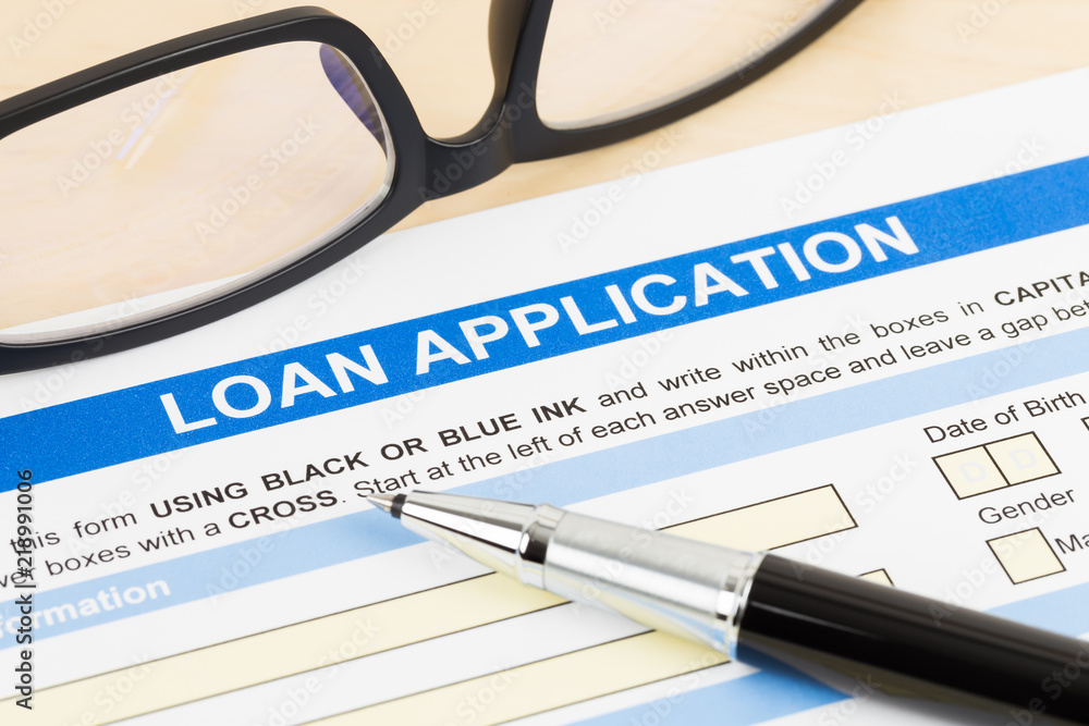Personal loan application form with glasses, and pen Personal loan application form with glasses, and pen