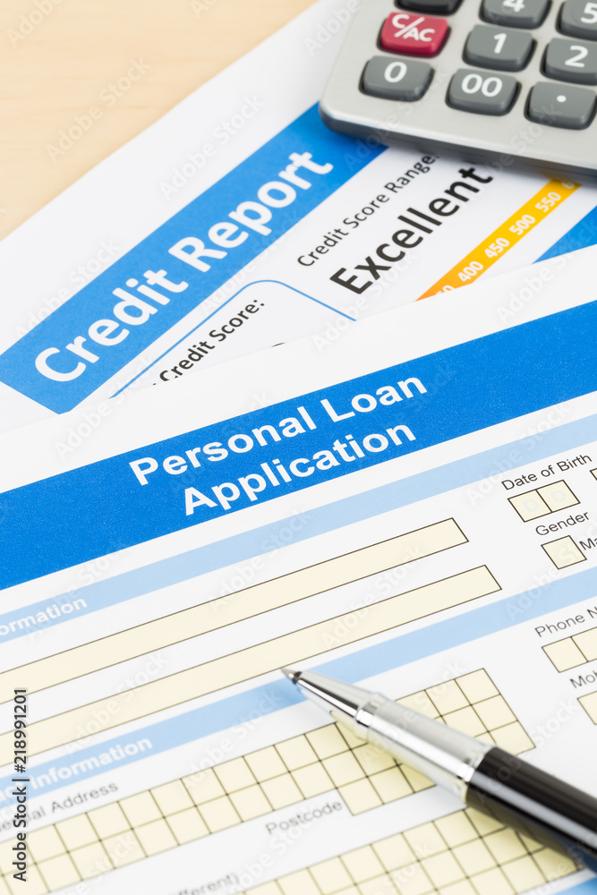 Personal loan application form excellent credit score with calculator, and pen Personal loan application form excellent credit score with calculator, and pen