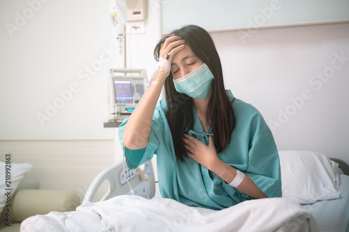 young woman patient sit on bed in hospital