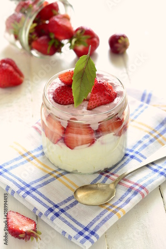 Cottage cheese with strawberries in a jar. Healthy nutrition, vertical