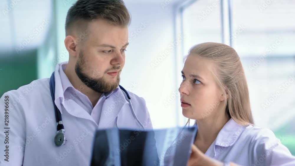 Close up portrait of two medical specialist discussing x-ray prints at hospital Close up portrait of two medical specialist discussing x-ray prints at hospital