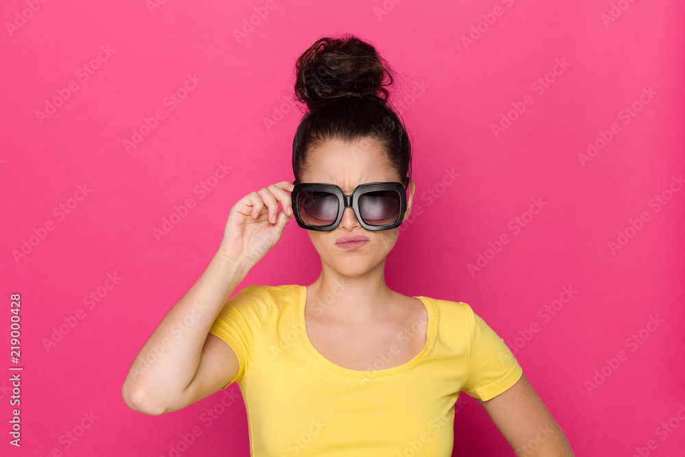 Grmacing Young Woman In Big Sunglasses Grmacing Young Woman In Big Sunglasses