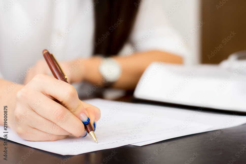 Business woman signing important documents Business woman signing important documents