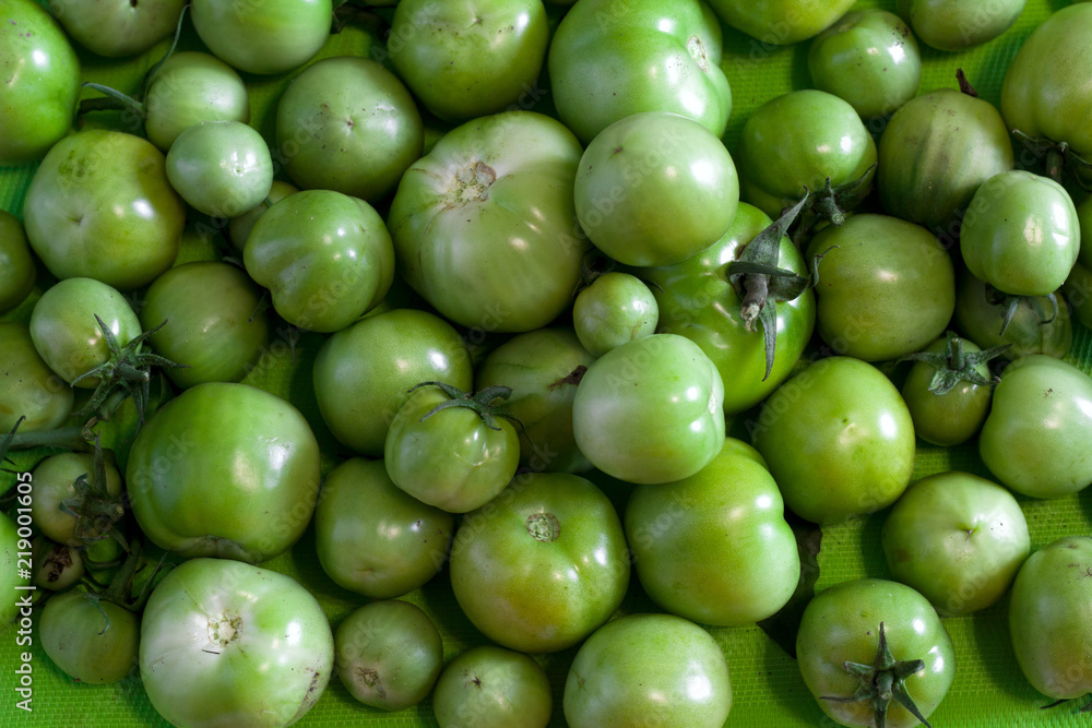 top view fresh green tomatoes in a box top view fresh green tomatoes in a box