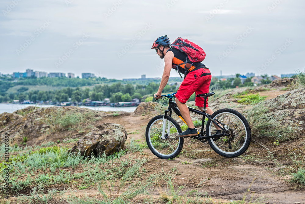 Cyclist descending down the rock on a mountain bike, an active lifestyle. Cyclist descending down the rock on a mountain bike, an active lifestyle.