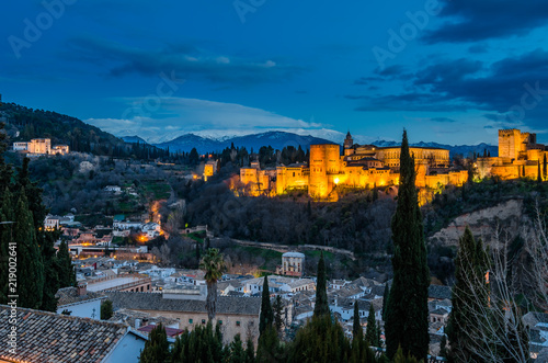 Night cityscape of Granada, Spain, with the Alhambra Palace in the background