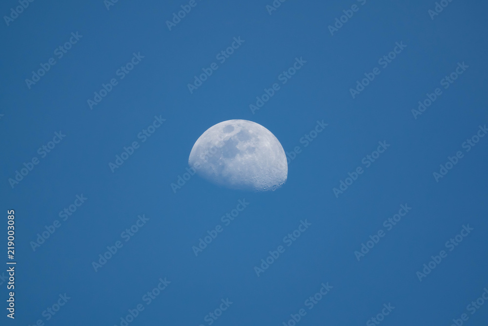 Half moon on blue sky background on daytime Half moon on blue sky background on daytime