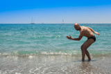 Man doing sports at the sea beach in summer