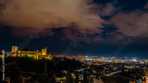 Night cityscape of Granada, Spain, with the Alhambra Palace in the background