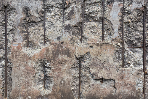 Broken concrete wall with iron grid