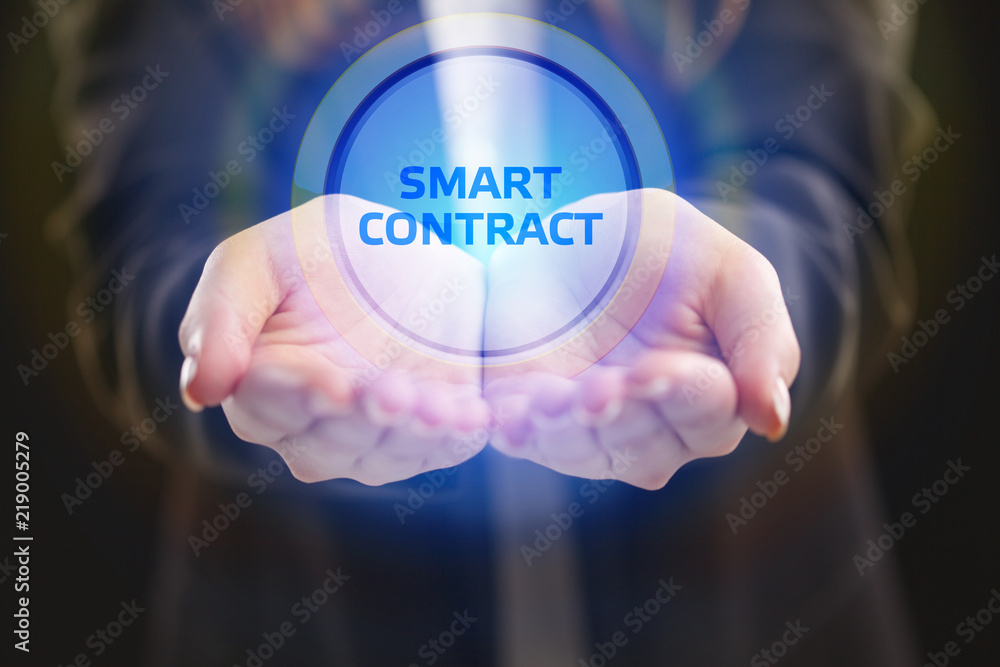 The concept of business, technology, the Internet and the network. A young entrepreneur working on a virtual screen of the future and sees the inscription: smart contract The concept of business, technology, the Internet and the network. A young entrepreneur working on a virtual screen of the future and sees the inscription: smart contract